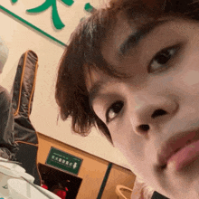 a person sitting at a table with a green sign that says " emergency exit "