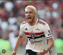 a soccer player wearing a jersey with the word spfc on it