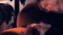a blurry picture of a person laying on a chair .