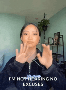 a woman says i 'm not hearing no excuses with her hands up