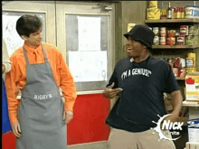 a man wearing a shirt that says i 'm a genius is standing next to another man