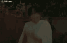 a woman in a white dress is laying on the ground with blood on her feet .