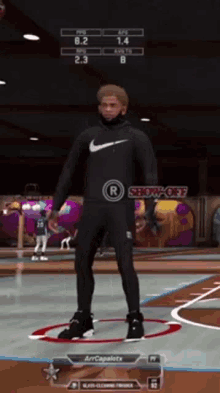 a man in a nike hoodie is standing on a basketball court in a video game