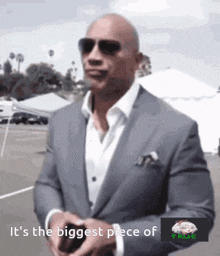 a bald man in a suit and sunglasses says it 's the biggest piece of true