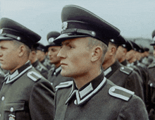a man in a military uniform has the letter c on his shoulder strap