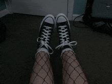 a pair of black and white sneakers with white laces