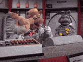 a couple of stuffed animals standing next to each other one of which is talking on a phone