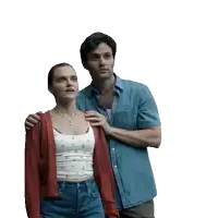 a man in a denim shirt is standing next to a woman in a white tank top