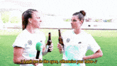 two female soccer players are holding beer bottles and singing " look me in the eyes "
