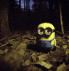 a yellow minion with big eyes is standing in a forest