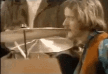 a close up of a person playing a drum set in a room .
