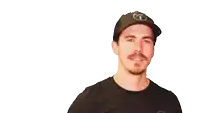 a man wearing a black hat with the letter t on it flexes his arm
