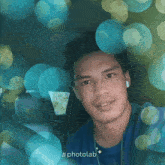 a man in a blue shirt is surrounded by blue bubbles and the hashtag photolab