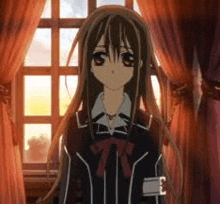 a girl is standing in front of a window in a room .