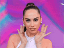 a woman is making a funny face with her hands