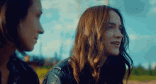 a man and a woman are standing next to each other and looking at each other