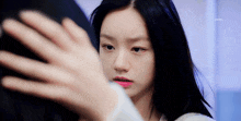 a close up of a woman taking a selfie with her hand on her face .