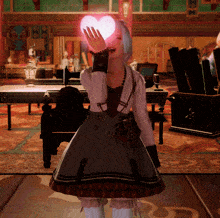 a woman in a dress holds a pink heart in her hand