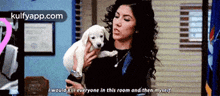 a woman is holding a small white puppy and says i would kill everyone in this room and then myself
