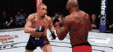 two men are fighting in a boxing ring with a metropcs banner in the background