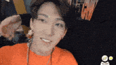 a man wearing an orange shirt with the word talker on the bottom