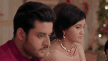 a man and a woman are sitting next to each other