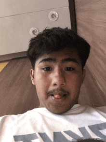 a young man with a mustache is wearing a t-shirt that says twice