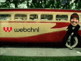 a man is standing in front of a bus that says webchnl on the side