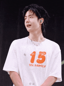 a man wearing a white t-shirt that says yh family