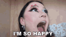 a woman with her mouth open and the words `` i 'm so happy '' on her face .