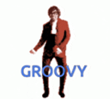 a man in a red suit is dancing and the word groovy is behind him