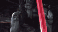 a close up of a person holding a sword in a video game with flames coming out of it .