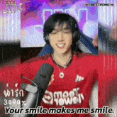 a man wearing headphones and a red shirt that says ' your smile makes me smile ' on it