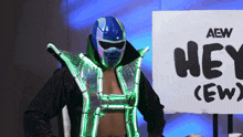 a wrestler standing in front of a sign that says hey