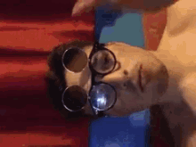 a man wearing glasses and goggles is laying down