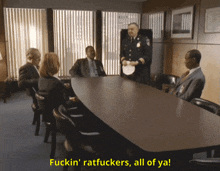 a group of people sitting around a table with the words fuckin ratfuckers all of ya