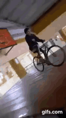 a person is riding a bike down a set of stairs with a gifs.com logo in the corner