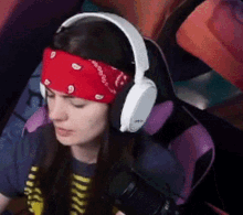 a woman wearing headphones and a bandana on her head .