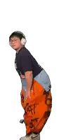 a man wearing headphones and orange pants has a sticker on his pants that says " at "