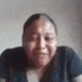 a blurry picture of a woman 's face with a dark shirt on