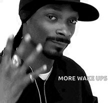 a black and white photo of snoop dogg with the words more wake ups on the bottom