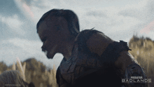 a poster for predator badlands shows a man in armor