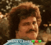 a man with curly hair and a mustache is giving a thank you baby .