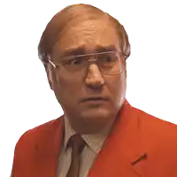 a man wearing glasses and a red suit is looking at the camera