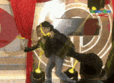 a man is dancing in front of a screen that says kapamilya online