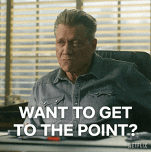 a man sitting at a desk with the words want to get to the point written below him