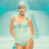 a woman is wearing a blue tinsel jacket and a hood