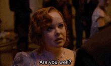 a woman with red hair and a necklace says are you well
