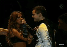 a man and a woman are standing next to each other on a stage