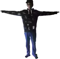 a person with their arms outstretched is wearing a black sweatshirt with a pattern of guns